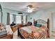 Relaxing primary bedroom features a ceiling fan and closet space at 3154 Prairie Dunes W Cir, Lakeland, FL 33810