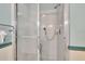 Close up of the shower featuring glass doors and a shower seat at 3154 Prairie Dunes W Cir, Lakeland, FL 33810