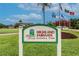 Community sign with mature landscaping, the sign says 