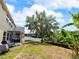 Expansive backyard with mature tree, patio, and fenced perimeter, perfect for outdoor activities at 3334 Fawnwood Dr, Ocoee, FL 34761