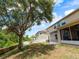 Backyard view featuring a large tree, patio, and fenced area, offering privacy and space at 3334 Fawnwood Dr, Ocoee, FL 34761