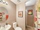 Well-lit bathroom with a pedestal sink, and decorative accents, providing a cozy and inviting space at 3334 Fawnwood Dr, Ocoee, FL 34761