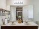 Bathroom featuring double sinks, a wide mirror, and modern fixtures for a luxurious feel at 3334 Fawnwood Dr, Ocoee, FL 34761