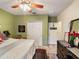 Cozy bedroom with green walls, plush bedding, and stylish decor accents throughout at 3334 Fawnwood Dr, Ocoee, FL 34761