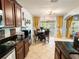 Bright and airy kitchen with dark countertops and cabinetry, open to dining area and great natural light at 3334 Fawnwood Dr, Ocoee, FL 34761