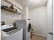 Functional laundry room equipped with modern washer and dryer and practical storage shelving at 3334 Fawnwood Dr, Ocoee, FL 34761