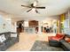 Open-concept living space with tile floors, connecting the living room, kitchen, and dining area at 3334 Fawnwood Dr, Ocoee, FL 34761