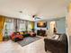Cozy living room features a comfortable sectional, decorative curtains, and a mounted TV at 3334 Fawnwood Dr, Ocoee, FL 34761