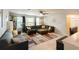 Inviting living room with a large sectional sofa, neutral colors, and plenty of natural light at 3334 Fawnwood Dr, Ocoee, FL 34761