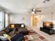 Comfortable living room features a sectional sofa, ottoman, ceiling fan, and stylish decor at 3334 Fawnwood Dr, Ocoee, FL 34761