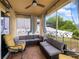 Relaxing screened patio featuring comfortable seating, ceiling fan, and views of the fenced yard at 3334 Fawnwood Dr, Ocoee, FL 34761