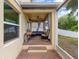 Covered patio with brick flooring, comfortable seating, and ceiling fan for outdoor relaxation at 3334 Fawnwood Dr, Ocoee, FL 34761