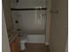 A compact bathroom with tile floors, a tub-shower, and a wooden vanity at 340 W Stanford St, Bartow, FL 33830