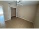 An open bedroom featuring a ceiling fan, tile floors, and a spacious closet at 340 W Stanford St, Bartow, FL 33830