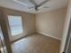 A cozy bedroom with tile flooring, a bright window, and neutral wall color at 340 W Stanford St, Bartow, FL 33830