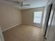 Neutral bedroom featuring tile floors, a bright window, and a ceiling fan at 340 W Stanford St, Bartow, FL 33830