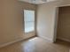 Neutral bedroom showcasing tile floors, a window with blinds, and a closet at 340 W Stanford St, Bartow, FL 33830
