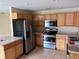 Well-lit kitchen features stainless steel appliances and wood cabinetry at 340 W Stanford St, Bartow, FL 33830