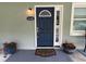 Stylish front door with decorative glass and potted plants enhancing the curb appeal at 4140 Old Dixie Hwy, Auburndale, FL 33823
