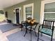 Cozy covered front porch with seating, enhancing the home's welcoming exterior at 4140 Old Dixie Hwy, Auburndale, FL 33823