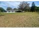 Ranch-style home with large front yard and mature oak trees at 4151 Boggy Creek Rd, Kissimmee, FL 34744