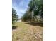 Residential land with mature shade trees, a house to the left, and grass lawn at 4151 Boggy Creek Rd, Kissimmee, FL 34744