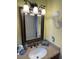 Vanity area with granite countertop, decorative mirror and seaside decor at 4805 Oak Acres Dr, Lake Wales, FL 33898