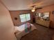 Cozy bedroom featuring a comfortable bed, window, dresser, and carpet flooring at 4805 Oak Acres Dr, Lake Wales, FL 33898