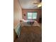 Bedroom featuring a comfy bed, ceiling fan, and neutral carpeting for a cozy, inviting atmosphere at 4805 Oak Acres Dr, Lake Wales, FL 33898