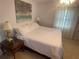 Bedroom featuring queen sized bed and a side table with a large lamp at 4805 Oak Acres Dr, Lake Wales, FL 33898