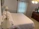 Bedroom featuring a bed with white linens, bedside lamps, a large window, and decor at 4805 Oak Acres Dr, Lake Wales, FL 33898