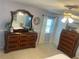 Spacious bedroom featuring large dressers, neutral carpet, ceiling fan and a view to the bed and bathroom at 4805 Oak Acres Dr, Lake Wales, FL 33898