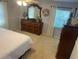 Bright bedroom featuring large dresser, ample natural light, neutral carpet, and seashell accents at 4805 Oak Acres Dr, Lake Wales, FL 33898