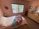 Bedroom featuring a single bed, neutral paint, window, and dresser at 4805 Oak Acres Dr, Lake Wales, FL 33898