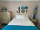 Bright bedroom featuring nautical wall decor, a dresser, and soft lighting at 4805 Oak Acres Dr, Lake Wales, FL 33898