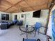 Relaxing outdoor covered patio with a TV, ceiling fan, and backyard at 4805 Oak Acres Dr, Lake Wales, FL 33898