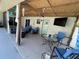 Inviting covered patio with comfortable seating, ceiling fans, and a wall-mounted TV at 4805 Oak Acres Dr, Lake Wales, FL 33898