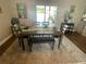 Comfortable dining area with table and bench, area rug, slider to the patio, and tropical decor at 4805 Oak Acres Dr, Lake Wales, FL 33898