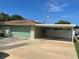 Two car garage with additional parking space under a covered carport at 4805 Oak Acres Dr, Lake Wales, FL 33898
