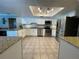 Bright kitchen features stainless steel appliances, tile floors, granite countertops, and white cabinetry at 4805 Oak Acres Dr, Lake Wales, FL 33898