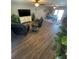 Open living room with hardwood floors, ceiling fans, comfortable seating, and a view of dining area at 4805 Oak Acres Dr, Lake Wales, FL 33898