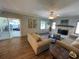 Bright living room with a decorative brick fireplace and access to the sunroom at 4805 Oak Acres Dr, Lake Wales, FL 33898