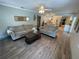 Inviting living room with wood-look tile flooring and an open view to the bright and modern kitchen at 4805 Oak Acres Dr, Lake Wales, FL 33898
