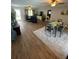 Spacious living room and dining area with wood flooring, ceiling fans, and a plush area rug at 4805 Oak Acres Dr, Lake Wales, FL 33898