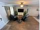 Inviting living room features wood floors, comfortable seating, and a ceiling fan for a cozy ambiance at 4805 Oak Acres Dr, Lake Wales, FL 33898