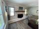 Cozy living room with brick fireplace, wood flooring and natural light at 4805 Oak Acres Dr, Lake Wales, FL 33898