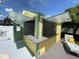 Poolside bar with granite countertop, yellow siding, and open windows, perfect for entertaining at 4805 Oak Acres Dr, Lake Wales, FL 33898