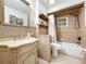 Elegant bathroom features a large vanity, tiled walls and flooring and a shower-tub combination at 4966 Foxrun Ln, Lakeland, FL 33813