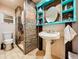 Stylish bathroom showcasing a vessel sink, custom cabinetry, walk-in shower, and tiled flooring at 4966 Foxrun Ln, Lakeland, FL 33813