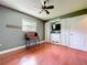 Cozy bedroom with wood floors, ceiling fan, a window, and closet with storage at 4966 Foxrun Ln, Lakeland, FL 33813